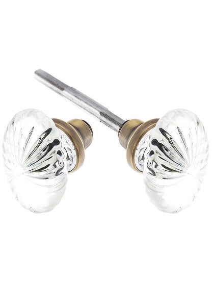 Pair of Oval Fluted Crystal Knobs in Antique Brass.
